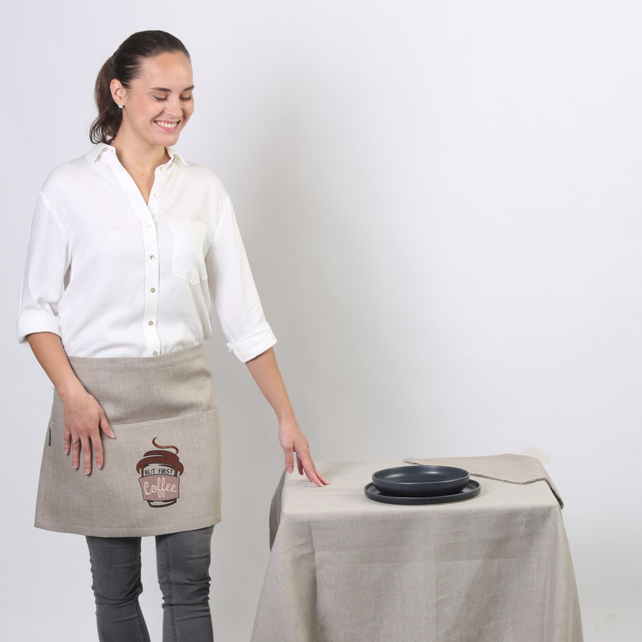 Girl smiling wearing But First Coffee Linen Waist apron