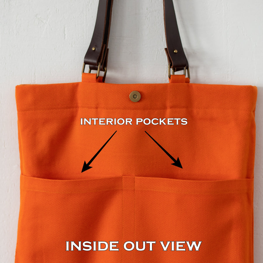 Inside out view of Oversized orange cotton canvas bag with daffodils and leather handles