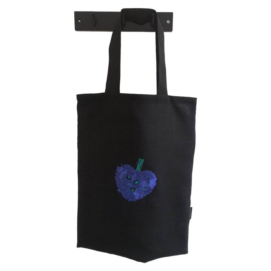 Black shoulder bag with blue poppy flower bouquet