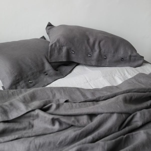 Dark grey bedding and white sheet