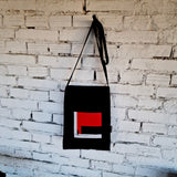 Front view of black linen and cotton canvas crossbody bag with urban-inspired red embroidery