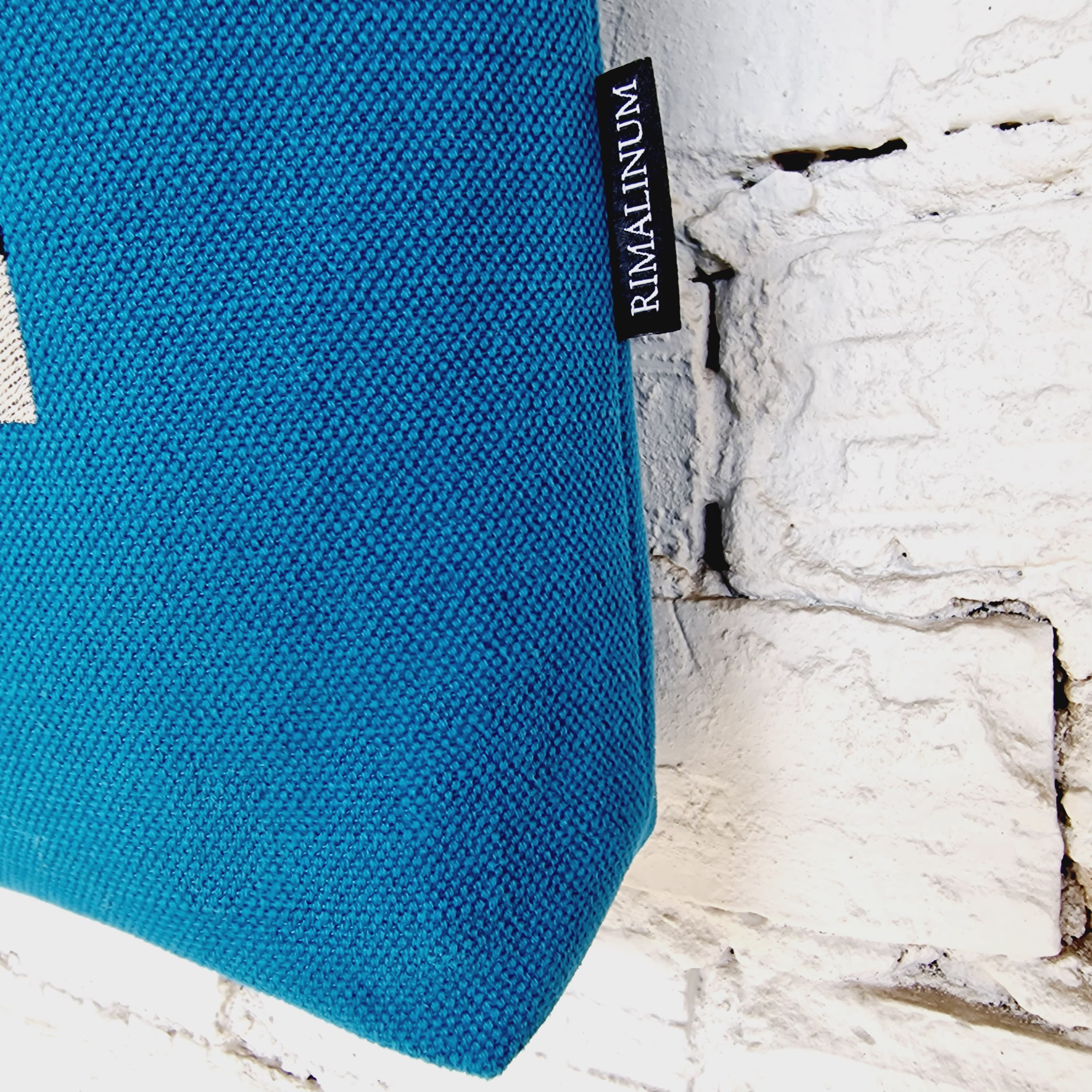 Close-up of blue linen and cotton canvas bag with Rimalinum logo tag