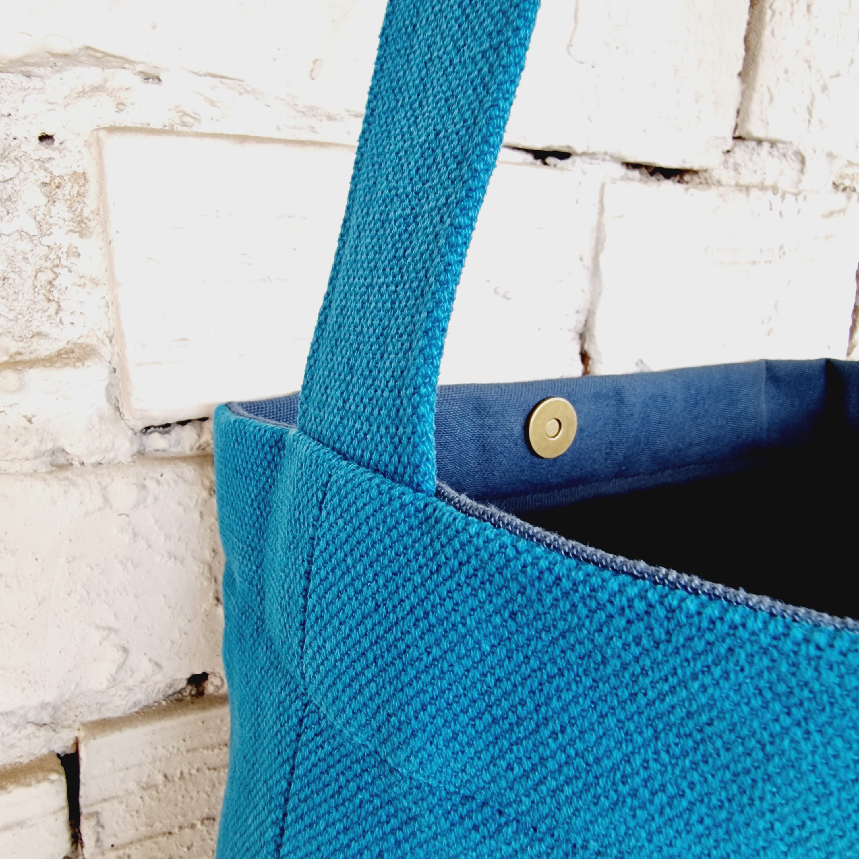 Interior view of handmade blue linen and cotton bag with snap button closure