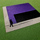 Close-up of urban-inspired embroidery on green canvas crossbody bag, featuring modern purple and black design.