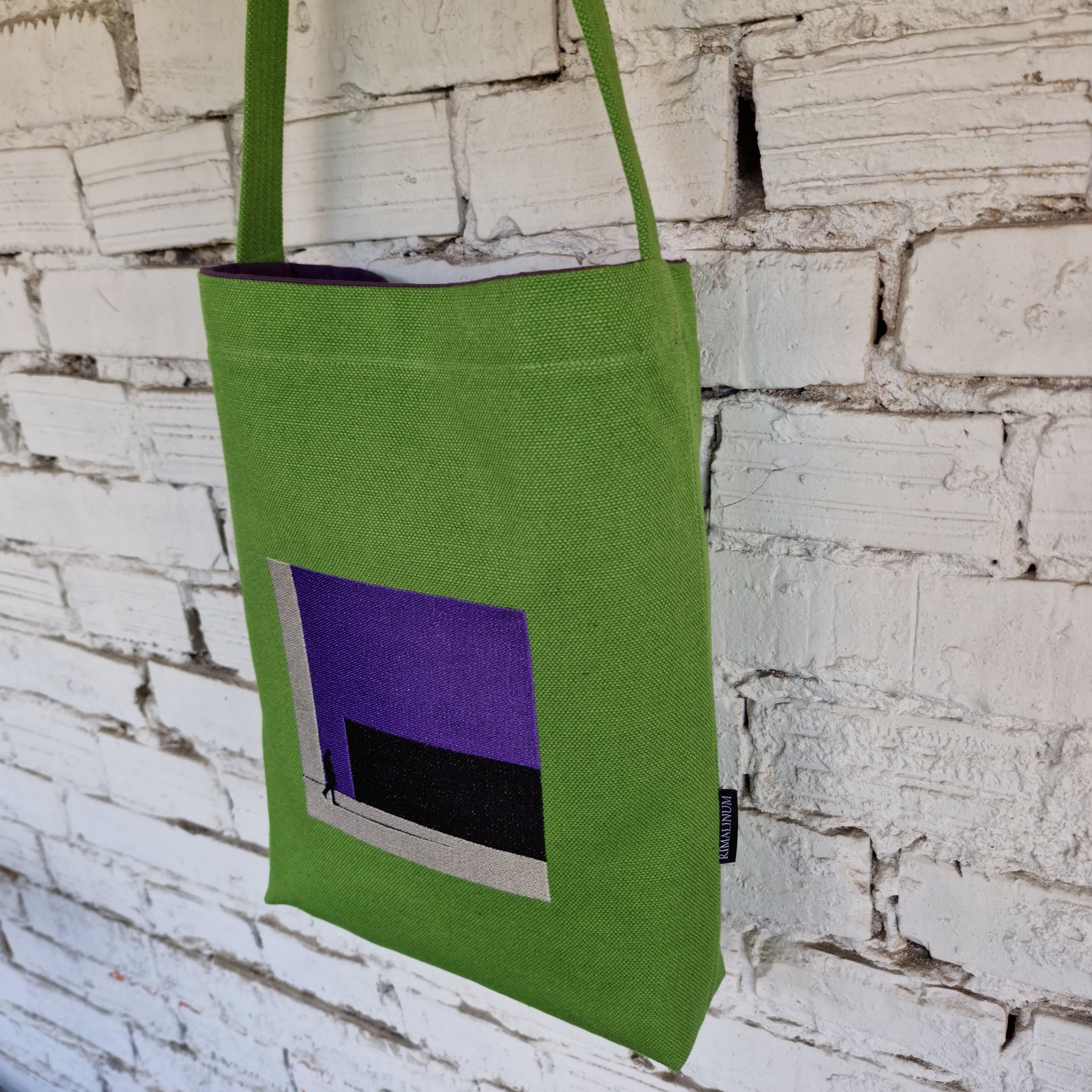 Side view of green canvas crossbody bag with 124 cm strap, showing compact size and sturdy strap.