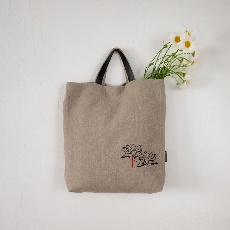 Handmade linen bag with lotus flower embroidery from small women-led business in Vilnius, Lithuania