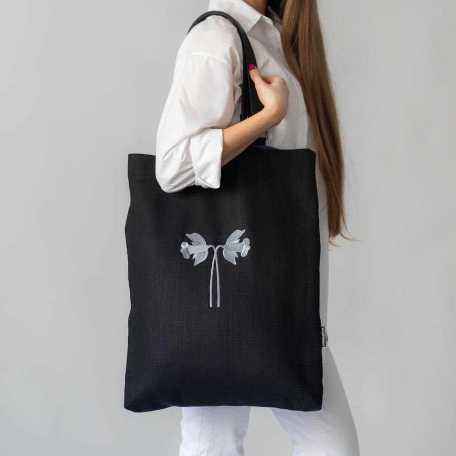 Oversized black canvas shoulder bag with embroidery and leather handles