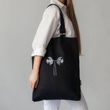 Oversized black canvas shoulder bag with embroidery and leather handles