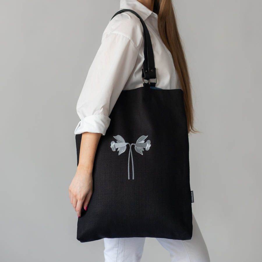 Oversized black canvas shoulder bag with embroidery and leather handles