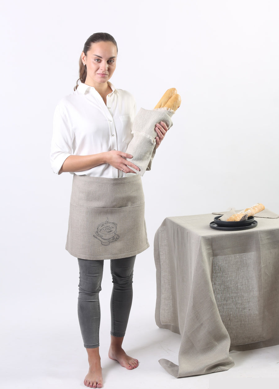 Waist apron on a model holding bread